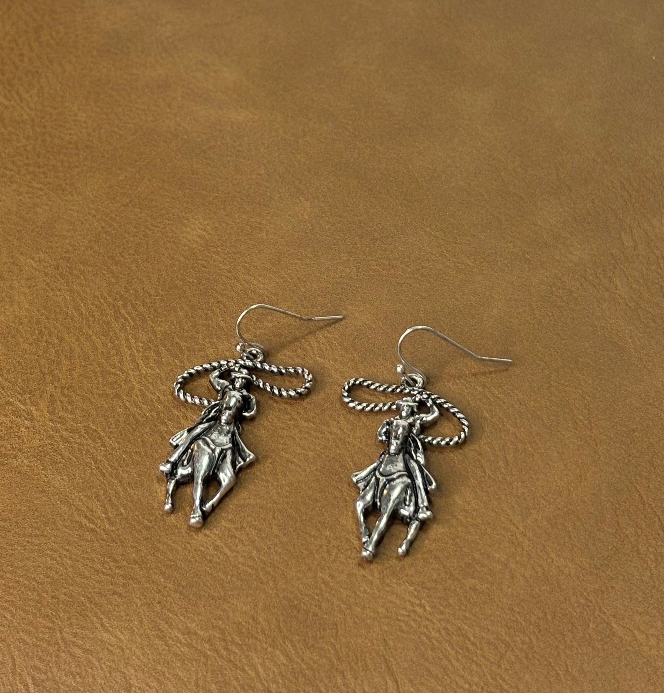 Roping cowboy earrings